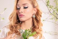 Beautiful young woman with blond curly hair, wears elegant clothes and bijou, Royalty Free Stock Photo