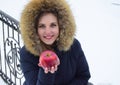 The beautiful young woman the blonde with blue eyes holds red apple in hand Royalty Free Stock Photo