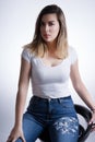 Elegant and Confident: Close-up Portrait of a Beautiful Woman with Blonde Brown Hair in Blue Jeans Royalty Free Stock Photo