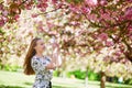 Beautiful young woman in blooming spring park Royalty Free Stock Photo