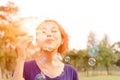 Beautiful young woman blowing bubble outdoor happy Royalty Free Stock Photo