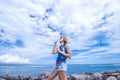 Beautiful young woman blowing bubble in outdoor, nature, near the ocean. Tropical magic island Bali, Indonesia. Royalty Free Stock Photo