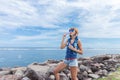 Beautiful young woman blowing bubble in outdoor, nature, near the ocean. Tropical magic island Bali, Indonesia. Royalty Free Stock Photo