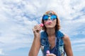 Beautiful young woman blowing bubble in outdoor, nature, near the ocean. Tropical magic island Bali, Indonesia. Royalty Free Stock Photo