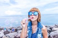 Beautiful young woman blowing bubble in outdoor, nature, near the ocean. Tropical magic island Bali, Indonesia. Royalty Free Stock Photo