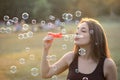 Beautiful Young Woman Blowing Bubbles Outside Royalty Free Stock Photo