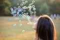 Beautiful Young Woman Blowing Bubbles Outside Royalty Free Stock Photo