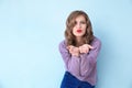 Beautiful young woman blowing kiss on color background Royalty Free Stock Photo