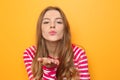 Beautiful young woman blowing kiss on color background Royalty Free Stock Photo