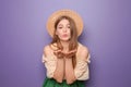 Beautiful young woman blowing kiss on color background Royalty Free Stock Photo