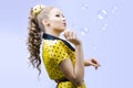 Beautiful young woman blowing soap bubbles Royalty Free Stock Photo