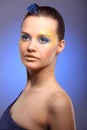 Beautiful young woman with blue creative make-up