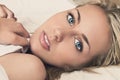 Beautiful Young Woman With Blue Eyes in Bed Royalty Free Stock Photo