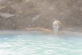 Beautiful young woman in Blue Lagoon geothermal spring , Iceland