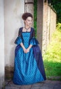 Beautiful young woman in blue medieval dress