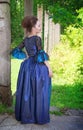 Beautiful young woman in blue medieval dress