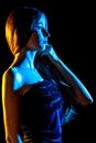 Beautiful young woman in blue and yellow lights Royalty Free Stock Photo