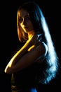 Beautiful young woman in blue and yellow lights Royalty Free Stock Photo