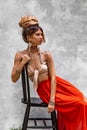 Beautiful young woman boho model posing with chair