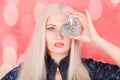 Beautiful young woman with bottle of perfume at home, closeup