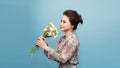 Beautiful young woman with bouquet of carnation on color background Royalty Free Stock Photo