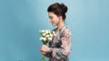 Beautiful young woman with bouquet of carnation flowers on color background Royalty Free Stock Photo