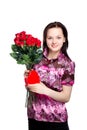 Beautiful young woman with a bouquet of red roses