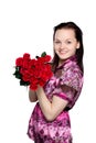 Beautiful young woman with a bouquet of red roses