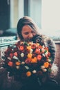 Beautiful young woman with a bouquet of roses and blurred cat Royalty Free Stock Photo