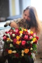 Beautiful young woman with a bouquet of roses and blurred cat Royalty Free Stock Photo