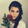 Beautiful young woman braided hair red rose Royalty Free Stock Photo