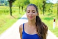 Beautiful young woman breathe with closed eyes enjoying the silence quiet tranquil spiritual reflection Royalty Free Stock Photo