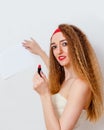 Beautiful young woman with bright makeup and red lipstick in her hands holds a white blank sheet of writing paper Royalty Free Stock Photo