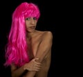 A beautiful young woman in a bright pink wig Royalty Free Stock Photo