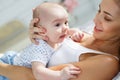 Mother playing with her newborn son lying on bed Royalty Free Stock Photo