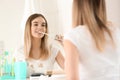 Beautiful young woman brushing her teeth in morning Royalty Free Stock Photo