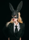 Beautiful young woman with bunny ears and blank poster on black background isolated. Hunting eggs. Bunny woman. Spring