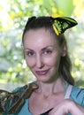 Beautiful young woman in a butterfly park with large tropical butterflies Royalty Free Stock Photo