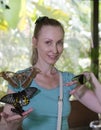 Beautiful young woman in a butterfly park with large tropical butterflies in her arms Royalty Free Stock Photo