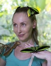 Beautiful young woman in a butterfly park with large tropical butterflies in her arms Royalty Free Stock Photo