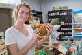 Beautiful young woman buying pineapple in fruit market Royalty Free Stock Photo