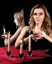 Beautiful young woman with candles near the mirror Royalty Free Stock Photo