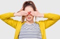 Beautiful young woman in casual outfit, covering her eyes with palms with red nails for a surprise for a birthday. Playful female