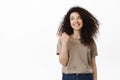 Beautiful young woman in casual outfit pointing finger left, looking aside at banner with happy white smile, showing Royalty Free Stock Photo