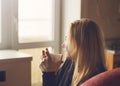 Beautiful young woman in casual wear dreaming with cup of coffee