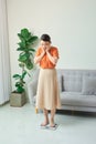 Beautiful young woman checking her weight on a simple white scale Royalty Free Stock Photo