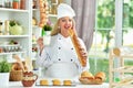 Portrait of beautiful young woman in chefs hat baking at home