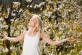 Beautiful young woman on cherry plantation in spring - cherry bl