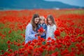 Beautiful young woman with child girl in poppy field. happy family having fun in nature. outdoor portrait in poppies. mother with Royalty Free Stock Photo