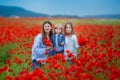 Beautiful young woman with child girl in poppy field. happy family having fun in nature. outdoor portrait in poppies. mother with Royalty Free Stock Photo